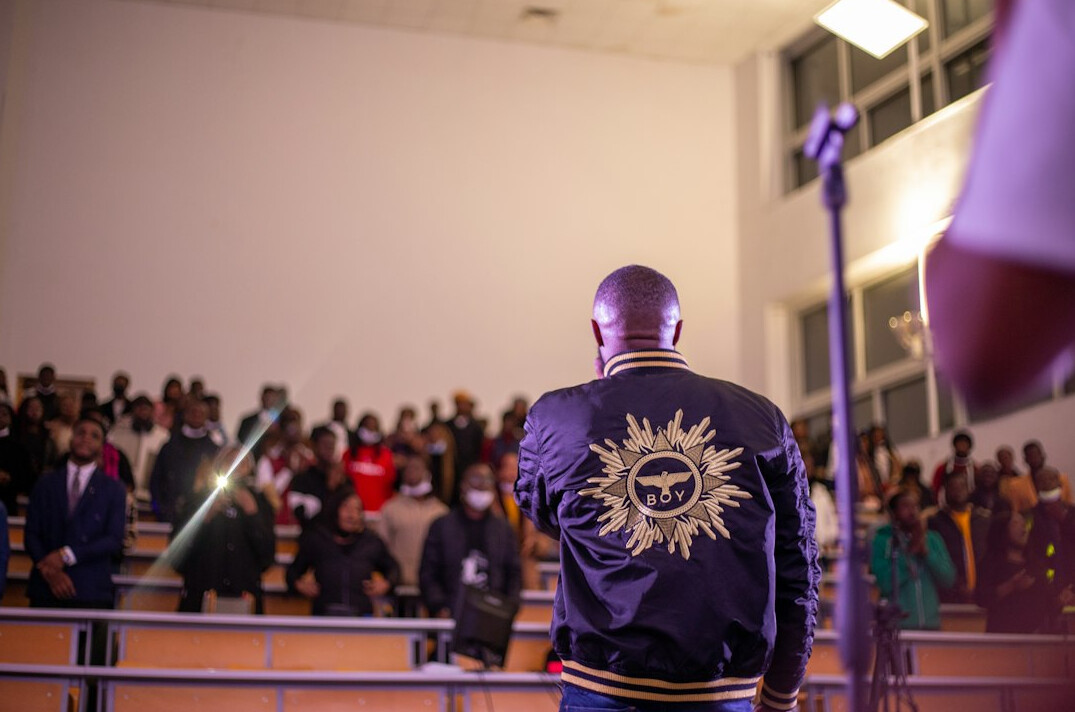 Speaker presenting on stage to an audience